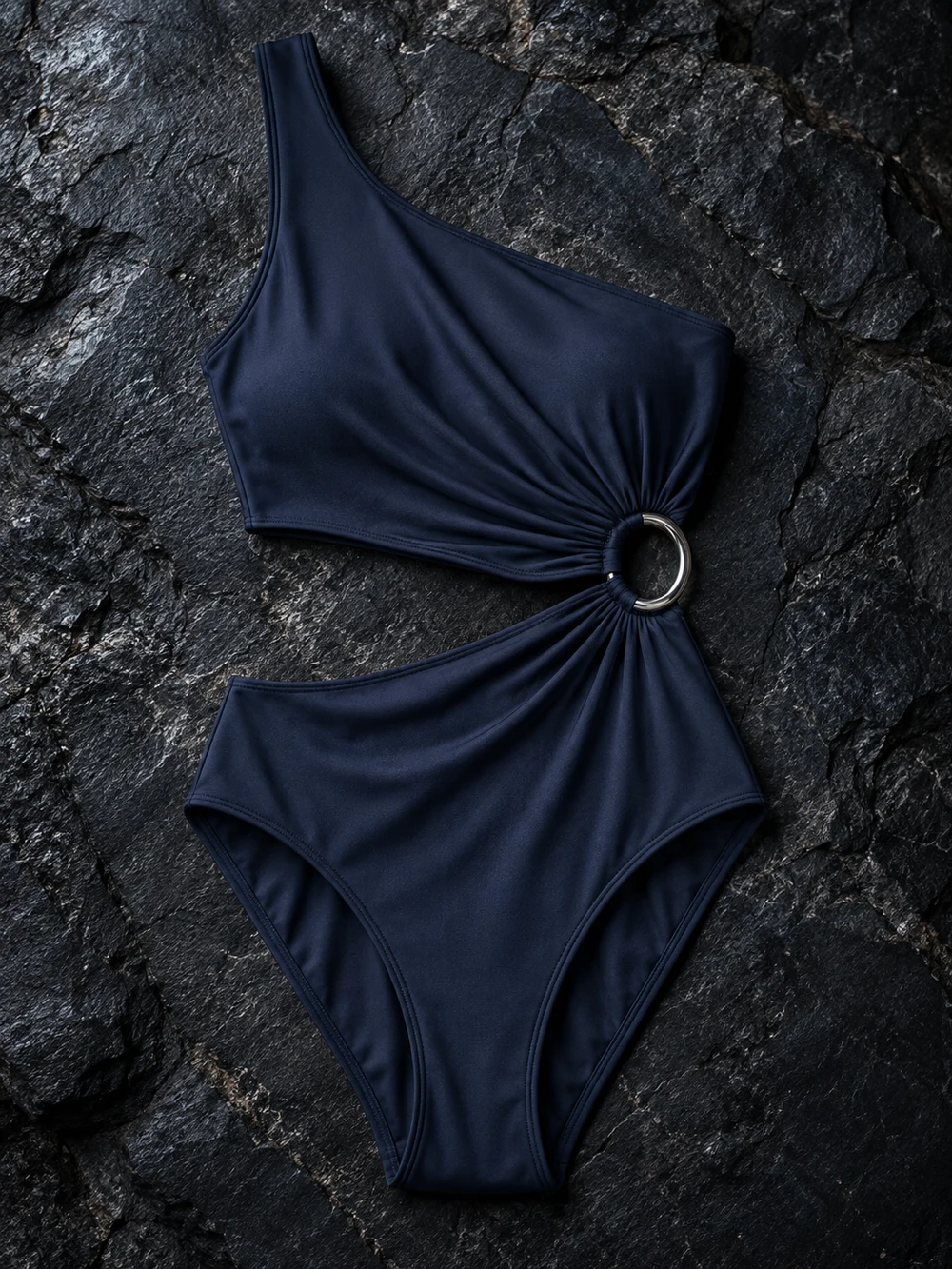 The Eclipse, a midnight blue asymmetric one-piece with a silver ring